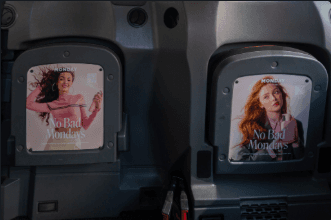Two tip seat advertising panels on the fold-down seats inside a classic London black cab