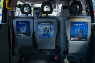 Three illuminated tip seat advertising panels on the fold-down seats inside a premium electric black cab